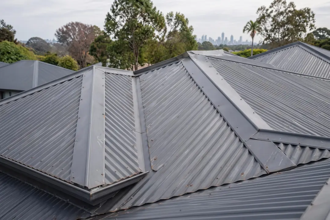 Grey corrugated metal roof with ridge and valley flashings